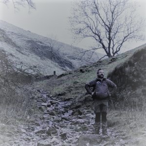 an image of Steve Greaves standing outdoors at the bottom of a hill side path